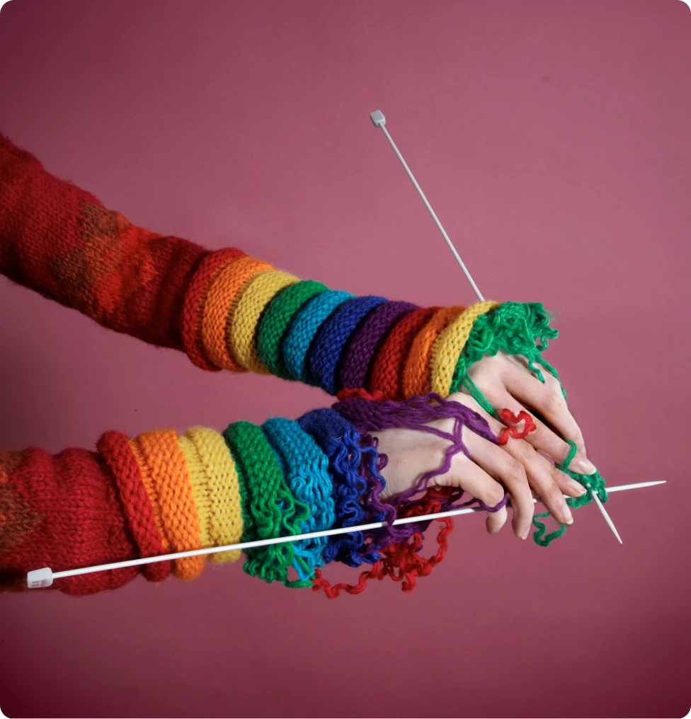 Colorful knitted sleeves with knitting needles