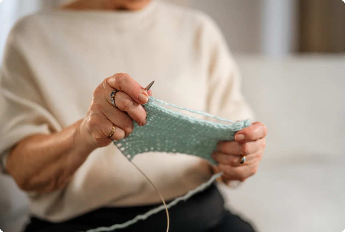 Close-up of hands knitting fabric
